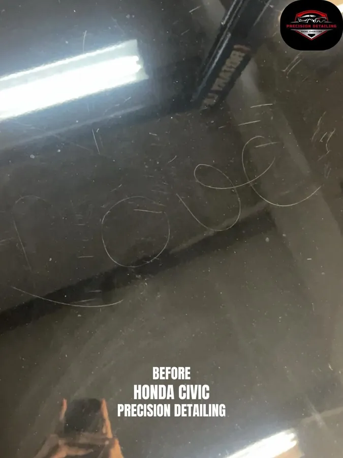 Swirl marks visible in dark paint before correction